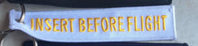 Insert Before Flight Keychain
